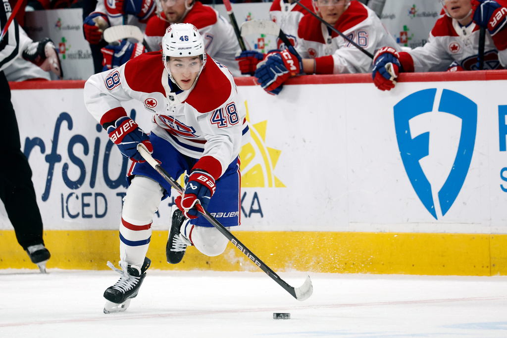 Montréal Canadiens' Lane Hutson (48) controls the puck against the Carolina Hurricanes during the first period of an NHL hockey game in Raleigh, N.C., Thursday, Jan. 1, 2026. (AP Photo/Karl DeBlaker)