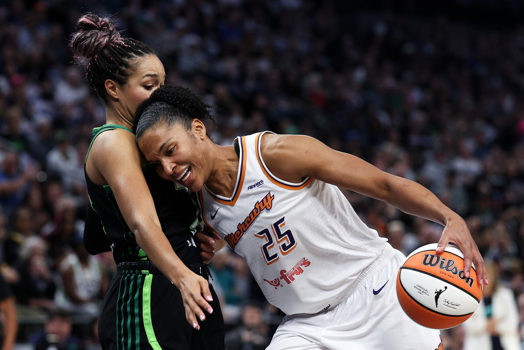 Phoenix Mercury forward Alyssa Thomas, right, drives toward the basket as Minnesota Lynx forward Napheesa Collier defends during the first half of Game 2 of a WNBA basketball playoff semifinals series Tuesday, Sept. 23, 2025, in Minneapolis. (AP Photo/Matt Krohn)