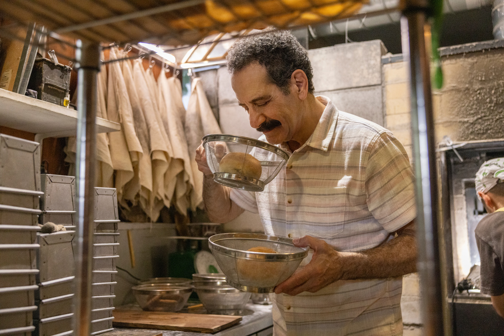 This image released by CNN shows Tony Shalhoub in a scene from his series "Breaking Bread," which follows the actor across the globe as he explores cultures and food through the lens of bread. (CNN via AP)