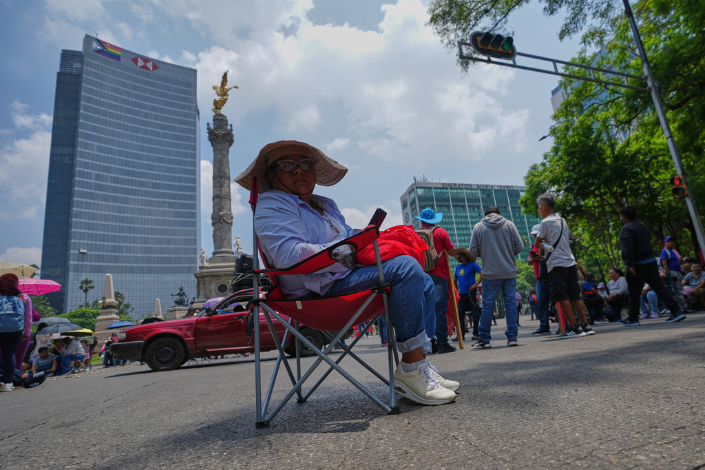 Teachers stage a protest at the Angel of Independence to demand salary increases in Mexico City, Tuesday, June 2, 2026. (AP Photo/Marco Ugarte)