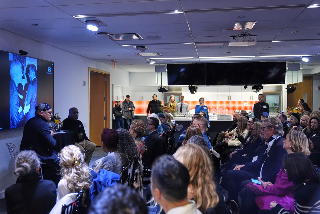 People watch as Isaac Mizrahi, left, listens to Jeffrey Banks, second from left, responds to questions during an interview Wednesday, Nov. 19, 2025, in New York. (AP Photo/Frank Franklin II)