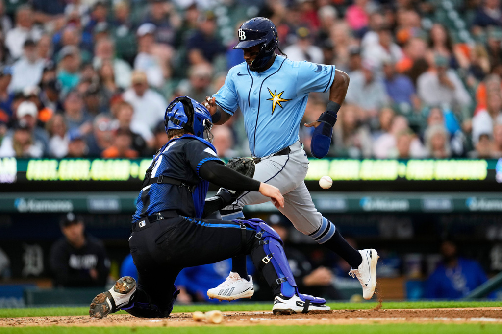 Tampa Bay Rays' Jorge Mateo, right, scores as Detroit Tigers catcher Dillon Dingler, left, waits for the throw during the fourth inning of a baseball game Monday, Aug. 24, 2026, in Detroit. (AP Photo/Paul Sancya)