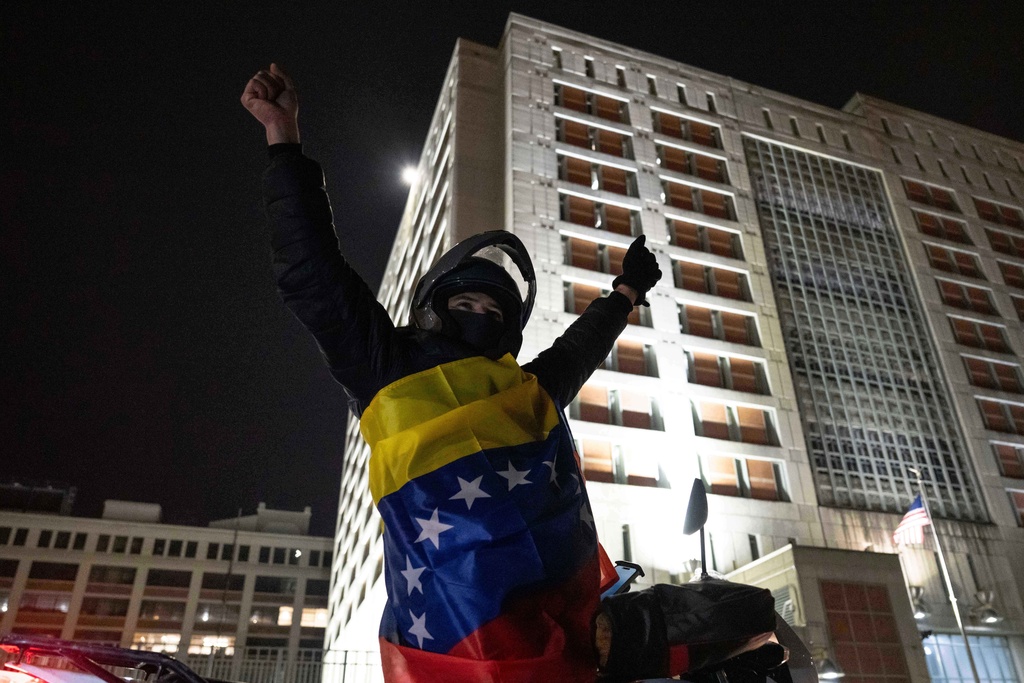 A Venezuelan immigrant critical of Venezuelan President Nicolas Maduro celebrates while wearing the country's flag outside the Metropolitan Detention Center, Saturday, Jan. 3, 2026, in New York. (AP Photo/Yuki Iwamura)