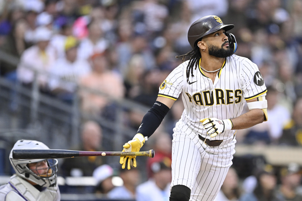 San Diego Padres' Fernando Tatis Jr. (23) hits a solo home run during the second inning of a baseball game against the Colorado Rockies Saturday, Sept. 13, 2025, in San Diego. (AP Photo/Denis Poroy)