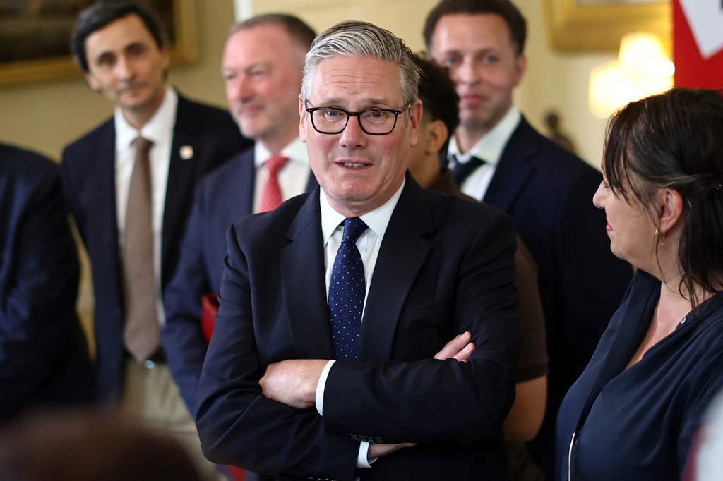Britain's Prime Minister Keir Starmer, center, speaks with people whose lives who are said to have been improved by the Labour Government, during a meeting inside 10 Downing Street, central London, Wednesday July 15, 2026. (Henry Nicholls/Pool Photo via AP)