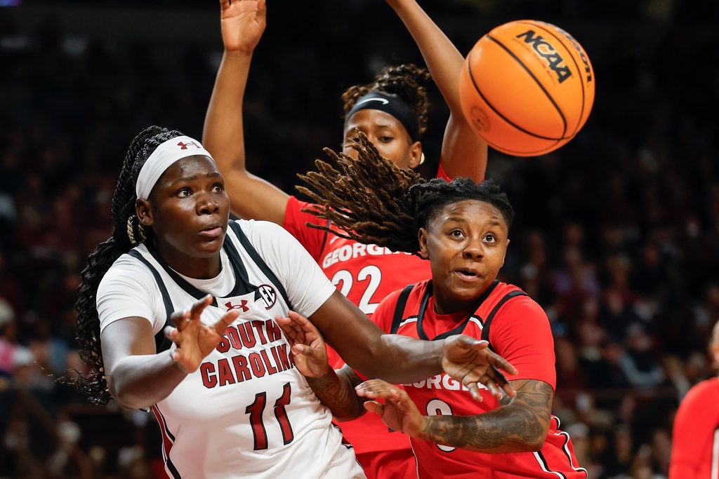 South Carolina center Madina Okot (11) battles Georgia guard Trinity Turner for a rebound during the first half of an NCAA college basketball game in Columbia, S.C., Sunday, Jan. 11, 2026. (AP Photo/Nell Redmond)