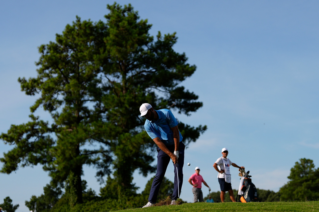 Scottie Scheffler hits on the second hole during the first round of the St. Jude Championship golf tournament, Thursday, Aug. 13, 2026, in Memphis, Tenn. (AP Photo/George Walker IV)
