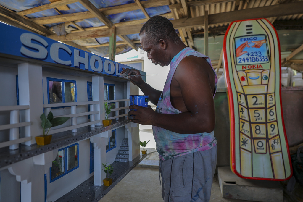 Joseph Adjetey works on a fantasy coffin at Eric Kpakpo's carpentry shop in La, Accra, Ghana, Wednesday, July 23, 2025. (AP Photo/Misper Apawu)