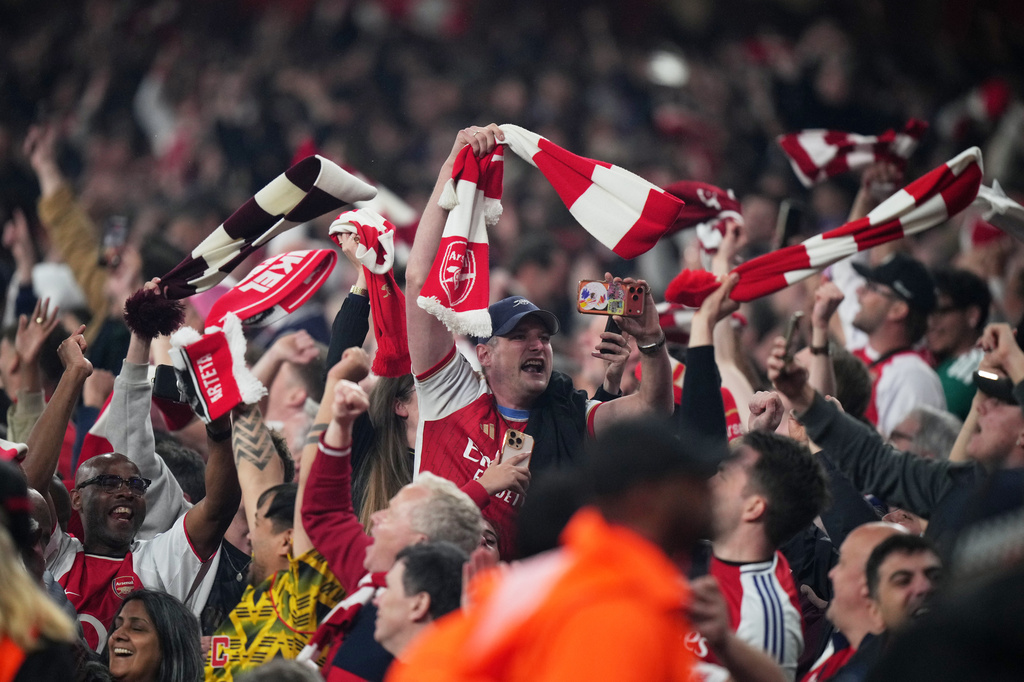Arsenal supporters celebrate at the the end of a Champions League semifinal, second leg, soccer match between Arsenal FC and Atletico Madrid in London, Tuesday, May 5, 2026. (AP Photo/Alastair Grant)