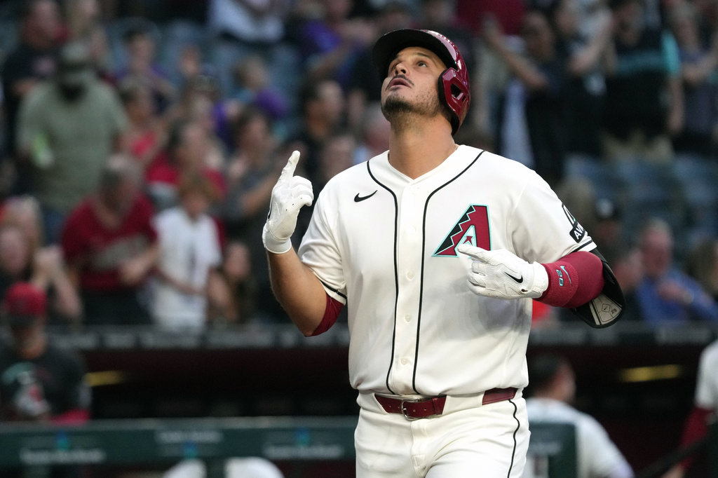 Arizona Diamondbacks' Nolan Arenado celebrates after hitting a grand slam against the San Francisco Giants in the first inning of a baseball game, Monday, May 18, 2026, in Phoenix. (AP Photo/Rick Scuteri)
