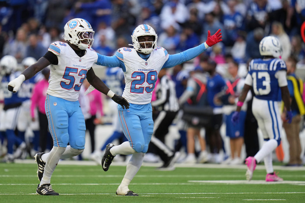 Tennessee Titans linebacker Anthony Hill Jr. (53) and safety Tony Adams (29) celebrate a fourth down defensive stop during the second half of an NFL football game against the Indianapolis Colts, Sunday, Oct. 18, 2026, in Indianapolis. (AP Photo/Jeff Roberson)