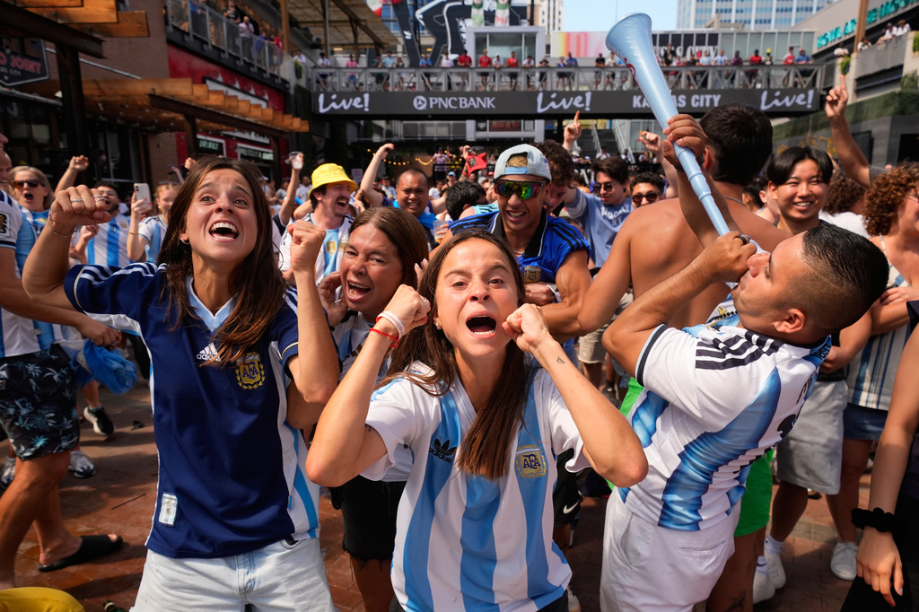 Fans celebrate Argentina's win in a World Cup semifinal soccer match against England during a watch party for at the KC Live! entertainment district Wednesday, July 15, 2026, in Kansas City, Mo. (AP Photo/Charlie Riedel)