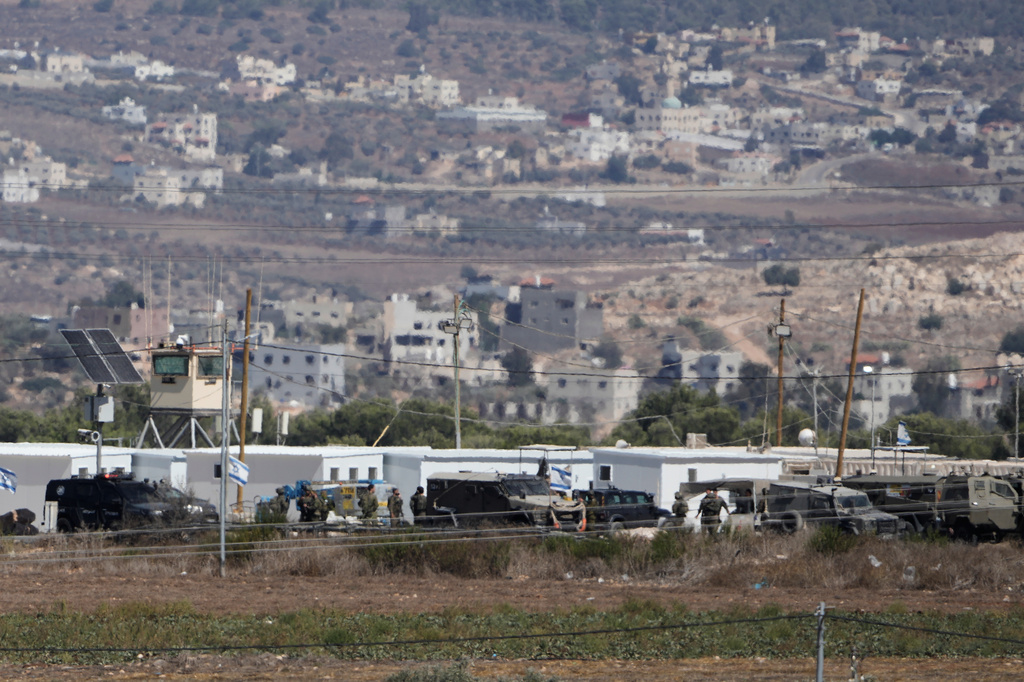 Israeli security forces work at the scene where the military said it killed a Palestinian man who attempted to carry out a ramming attack against soldiers at an intersection near the West Bank city of Jenin, Sunday, Sept. 20, 2026. (AP Photo/Majdi Mohammed)