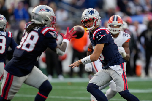 New England Patriots quarterback Drake Maye (10) flips the ball to running back Rhamondre Stevenson (38) in the second half of an NFL football game against the Cleveland Browns on Sunday, Oct. 26, 2025, in Foxborough, Mass. (AP Photo/Charles Krupa) New England Patriots quarterback Drake Maye (10) flips the ball to running back Rhamondre Stevenson (38) in the second half of an NFL football game against the Cleveland Browns on Sunday, Oct. 26, 2025, in Foxborough, Mass. (AP Photo/Charles Krupa)