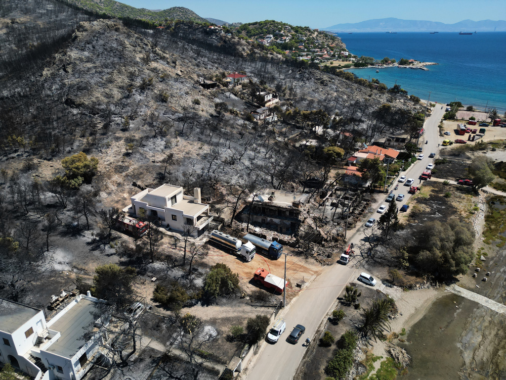 A view of a burned area a day after a wildfire in Peristeria village on the island of Salamina, west of Athens, Greece, Monday, Aug. 17, 2026. (AP Photo/Thanassis Stavrakis)