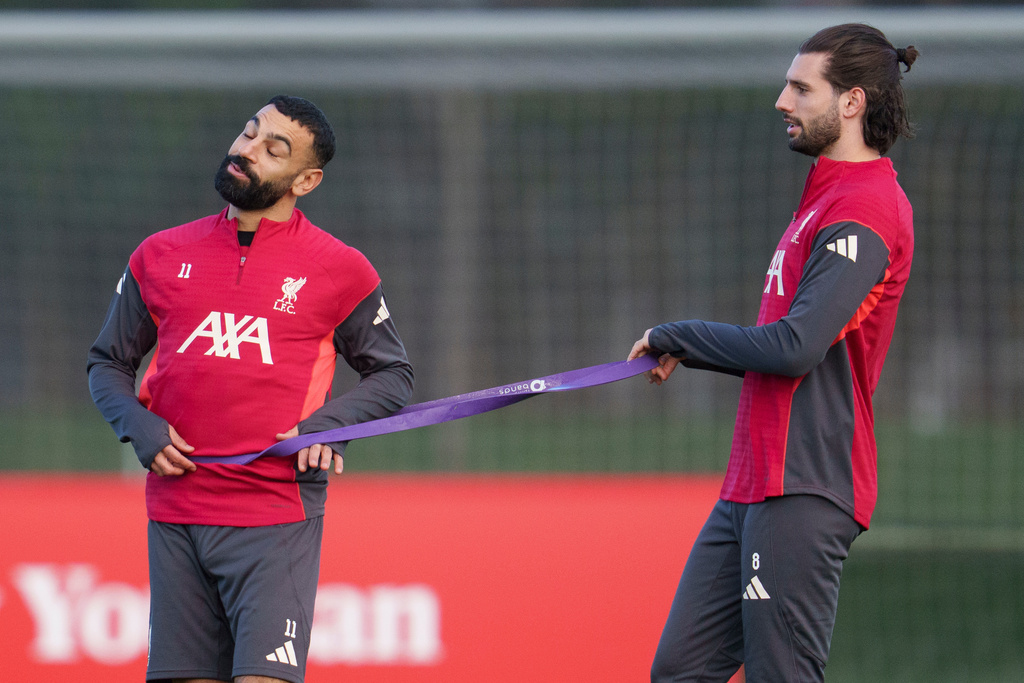 Liverpool's Mohamed Salah, left, uses a resistance band with teammate Dominik Szoboszlai as they take part in a training session in Liverpool, England, Monday, Dec. 8, 2025. (AP Photo/Jon Super)