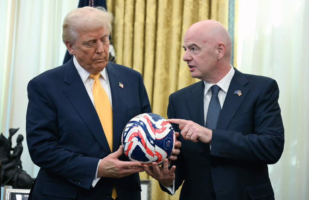 FILE - FIFA President Gianni Infantino, right, presents President Donald Trump with the new FIFA Club World Cup official ball in the Oval Office of the White House in Washington, March 7, 2025. (Jim Watson/Pool Photo via AP, file)