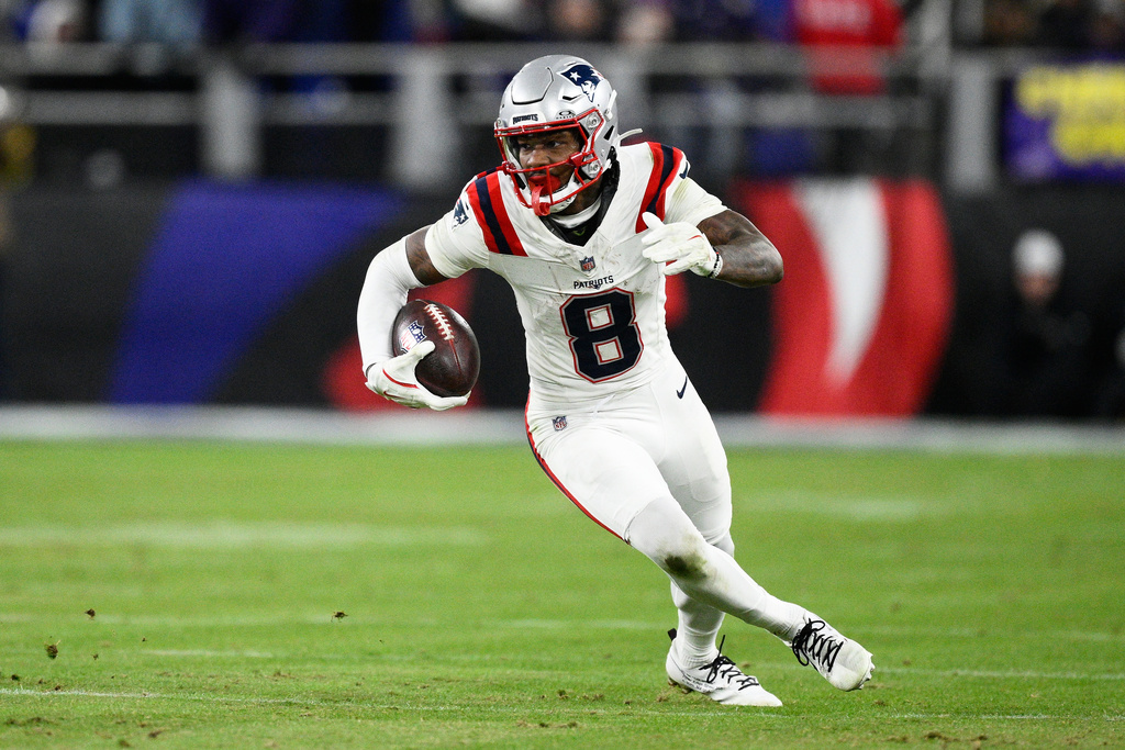 New England Patriots wide receiver Stefon Diggs (8) runs against the Baltimore Ravens during the second half of an NFL football game, Sunday, Dec. 21, 2025, in Baltimore. (AP Photo/Nick Wass)