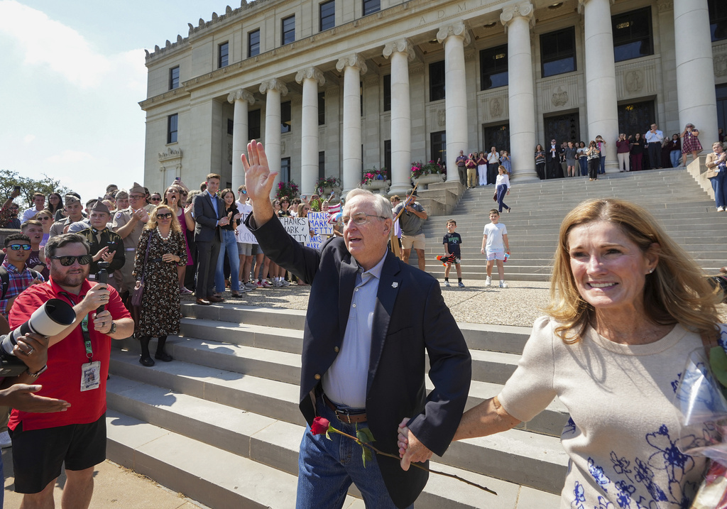 Texas A&M University President Mark Welsh, accompanied by his wife, Betty, exits the administration building after resigning in College Station, Texas, on Friday, Sept. 19, 2025. (Jay Janner/Austin American-Statesman via AP)