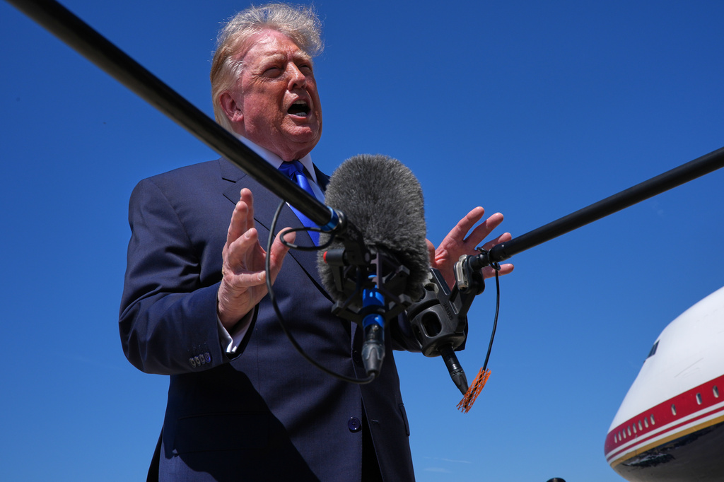 President Donald Trump talks with reporters after an emergency inflatable slide deployed on Air Force One before before Trump arrived to board at Joint Base Andrews, Md., Wednesday, Sept. 9, 2026. (AP Photo/Jacquelyn Martin)