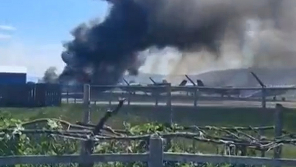 In this image made from video provided by Ron Danielson, a plane crashes into a parked aircraft at Kalispell City Airport, triggering a large fire, in Kalispell, Mont., Monday, Aug. 11, 2025. (Ron Danielson via AP)