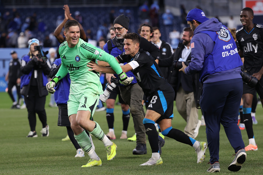 Charlotte FC goalkeeper Kristijan Kahlina (1) and midfielder Ashley Westwood (8) react after defeating New York City FC in a shoot out in the first round of MLS soccer's Eastern Conference playoffs Saturday, Nov. 1, 2025, in New York. (AP Photo/Pamela Smith)
