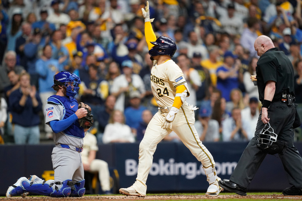 Milwaukee Brewers' William Contreras (24) celebrates while crossing home plate after hitting a solo home run during the third inning of Game 2 of baseball's National League Division Series against the Chicago Cubs Monday, Oct. 6, 2025, in Milwaukee. (AP Photo/Kayla Wolf)