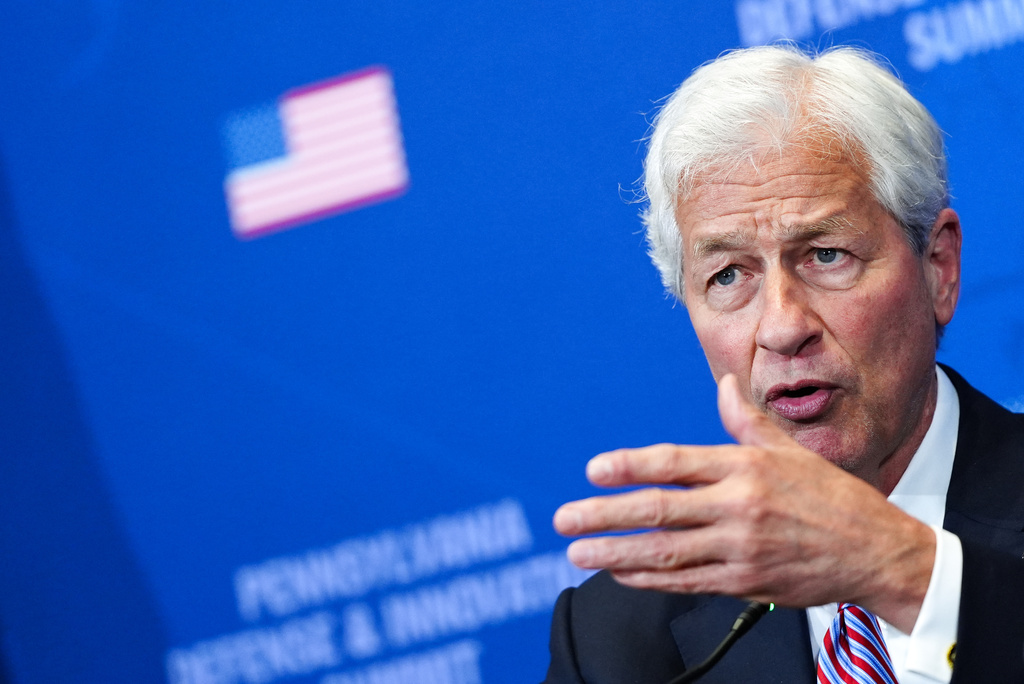 FILE - Jamie Dimon, chairman and CEO of JP Morgan Chase, listens as President Donald Trump speaks during a roundtable at the Pennsylvania Defense and Innovation Summit, Wednesday, July 15, 2026, at the United States Army War College in Carlisle, Pa. (AP Photo/Julia Demaree Nikhinson, File)