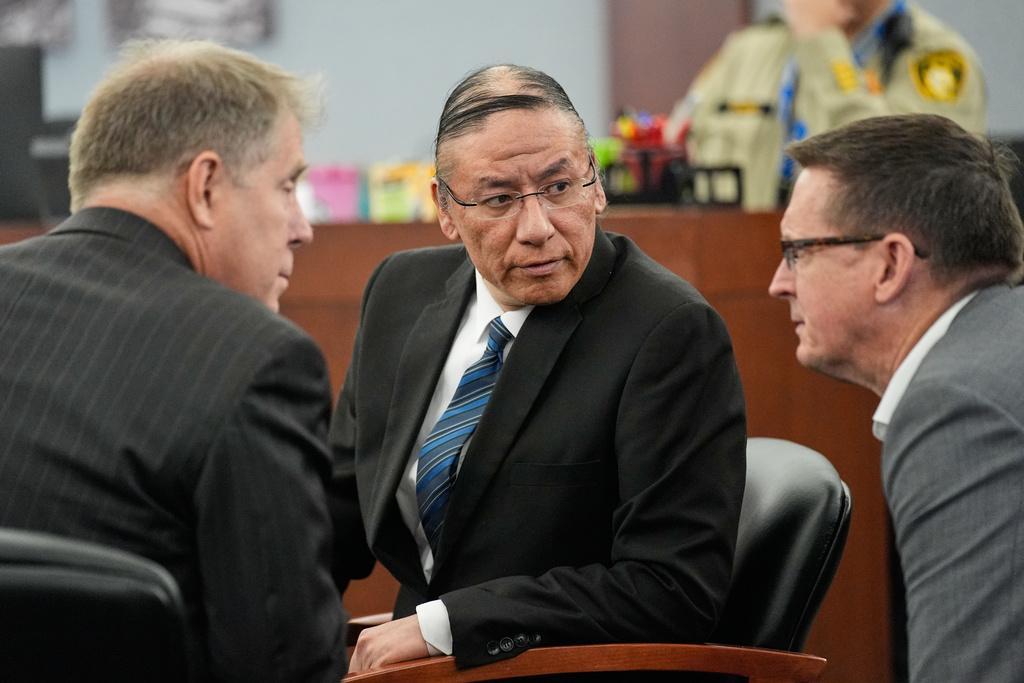 Nathan Chasing Horse, center, confers with attorneys as he appears in court for his trial on charges of sexually abusing Indigenous women and girls Tuesday, Jan. 20, 2026, in Las Vegas. (AP Photo/John Locher)