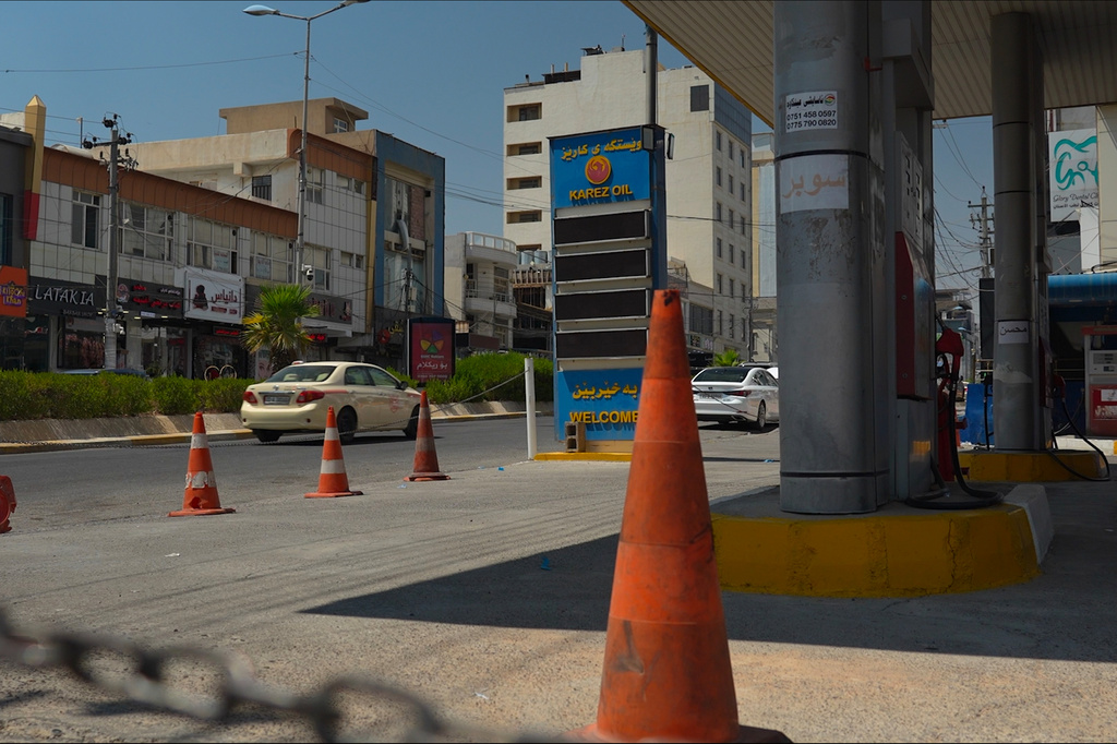 Vehicles drive past a closed gas station during a fuel shortage in Irbil, Iraq, Tuesday, July 28, 2026. (AP Photo/Stella Martany)