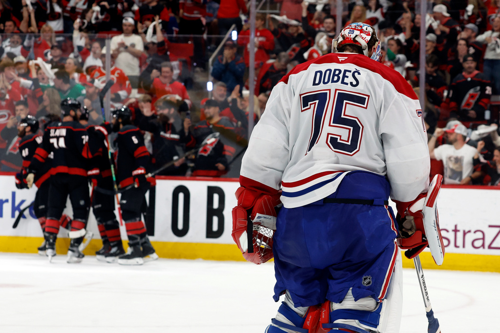 Carolina Hurricanes players celebrate after a goal by Nikolaj Ehlers as Montreal Canadiens goaltender Jakub Dobes (75) returns to the net during the second period in Game 2 of the Eastern Conference final NHL hockey Stanley Cup playoff series in Raleigh, N.C., Saturday, May 23, 2026. (AP Photo/Karl DeBlaker)