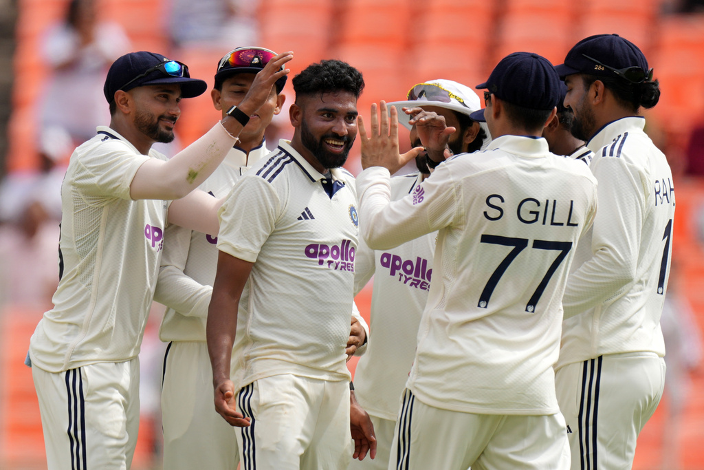 India's Mohammed Siraj, center, celebrates with teammates after the dismissal of West Indies' Brandon King on the first day of the first Test cricket match between India and West Indies at Narendra Modi Stadium in Ahmedabad, India, Thursday, Oct. 2, 2025. (AP Photo/Ajit Solanki)