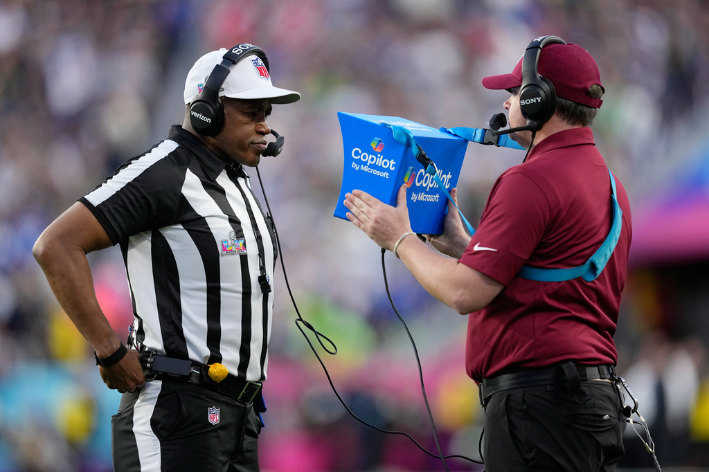 FILE - Referee Shawn Smith, left, reviews a play during the NFL Super Bowl 60 football game between the Seattle Seahawks and the New England Patriots, Sunday, Feb. 8, 2026, in Santa Clara, Calif. (AP Photo/Julio Cortez, File)
