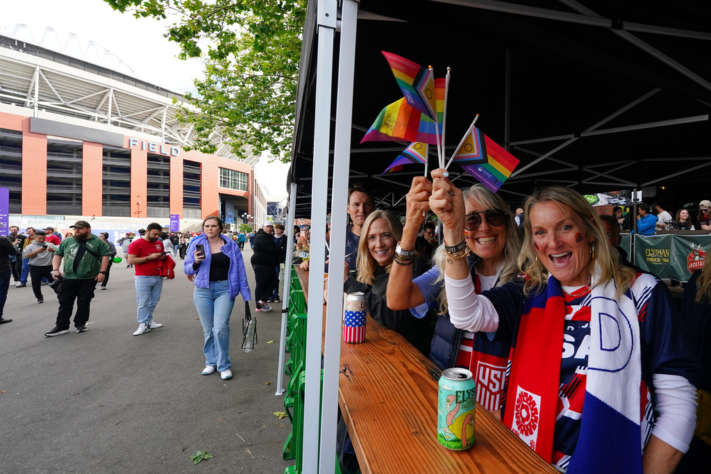 Fans wave Pride flags at a beer garden outside the stadium before the World Cup Group G soccer match between Egypt and Iran in Seattle, Friday, June 26, 2026. (AP Photo/Ted S. Warren)