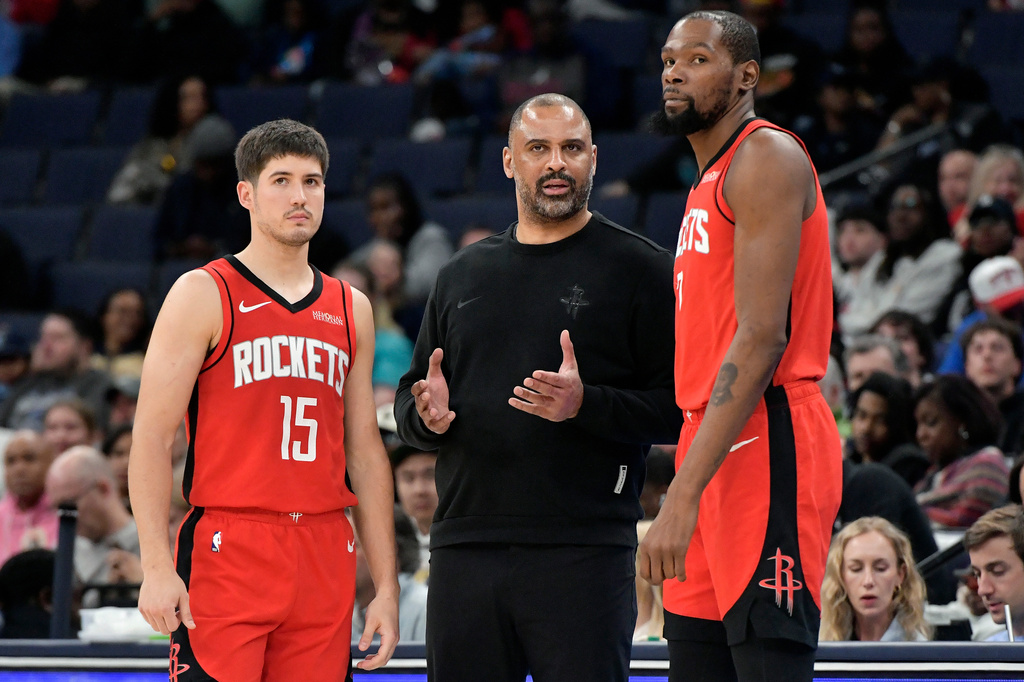 Houston Rockets head coach Ime Udoka, center, talks with guard Reed Sheppard (15) and forward Kevin Durant, right, in the second half of an NBA basketball game against the Memphis Grizzlies Friday, March 27, 2026, in Memphis, Tenn. (AP Photo/Brandon Dill)