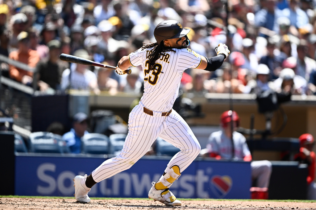 San Diego Padres' Fernando Tatis Jr. (23) hits an RBI single during the fifth inning of a baseball game against the Cincinnati Reds, Wednesday, June 10, 2026, in San Diego. (AP Photo/Denis Poroy)