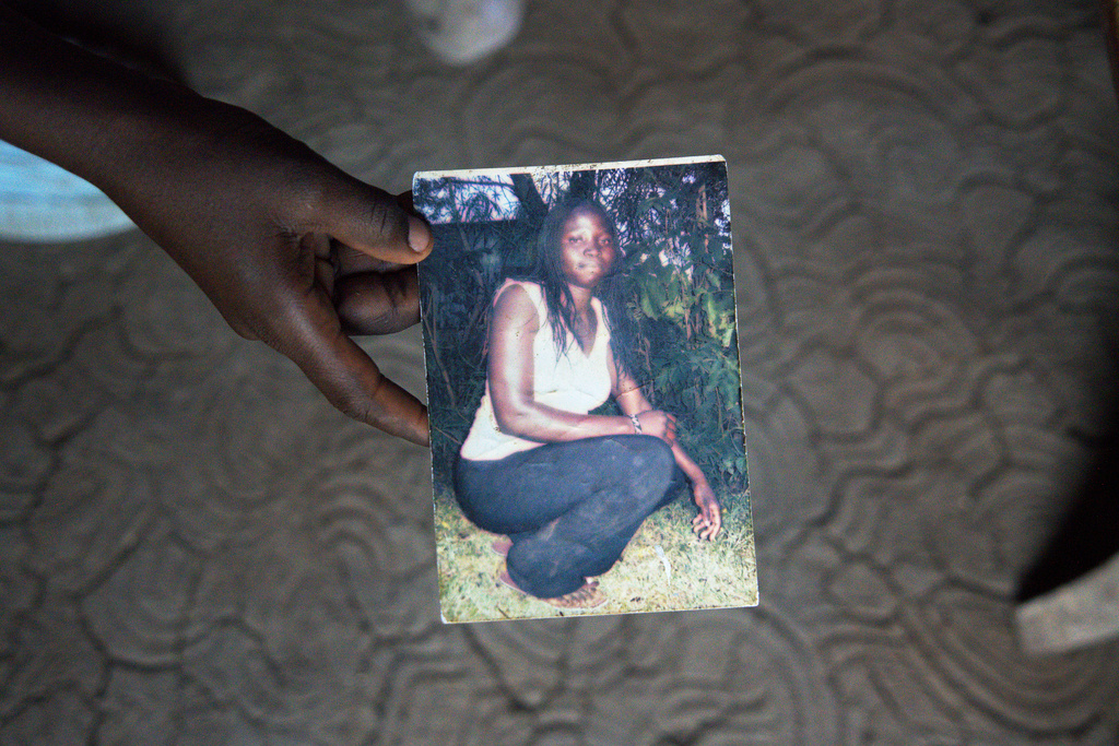 The son of Mary Olouch, who died at 25 after a botched abortion procedure, holds a photo of her in her home in Karabok, Kenya, July 20, 2025. (AP Photo/Annie Risemberg)