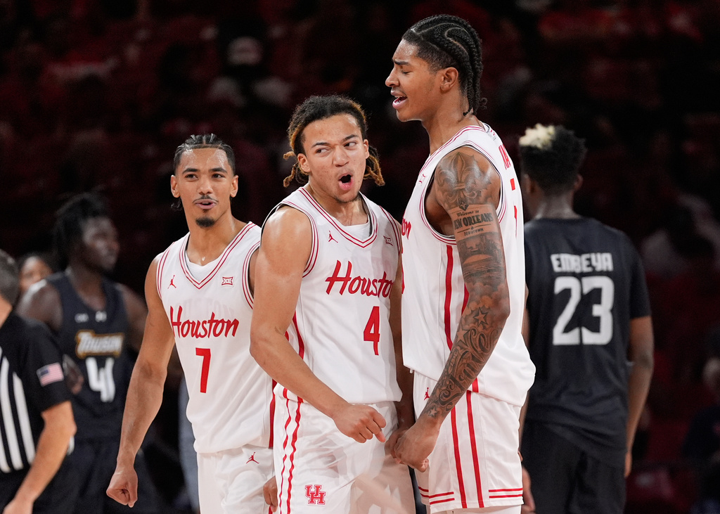 Houston guard Milos Uzan (7), guard Kingston Flemings (4) and center Chris Cenac Jr. (5) celebrate during the second half of an NCAA college basketball game against the Towson Tigers in Houston, Saturday, Nov. 8, 2025. (AP Photo/Ashley Landis)