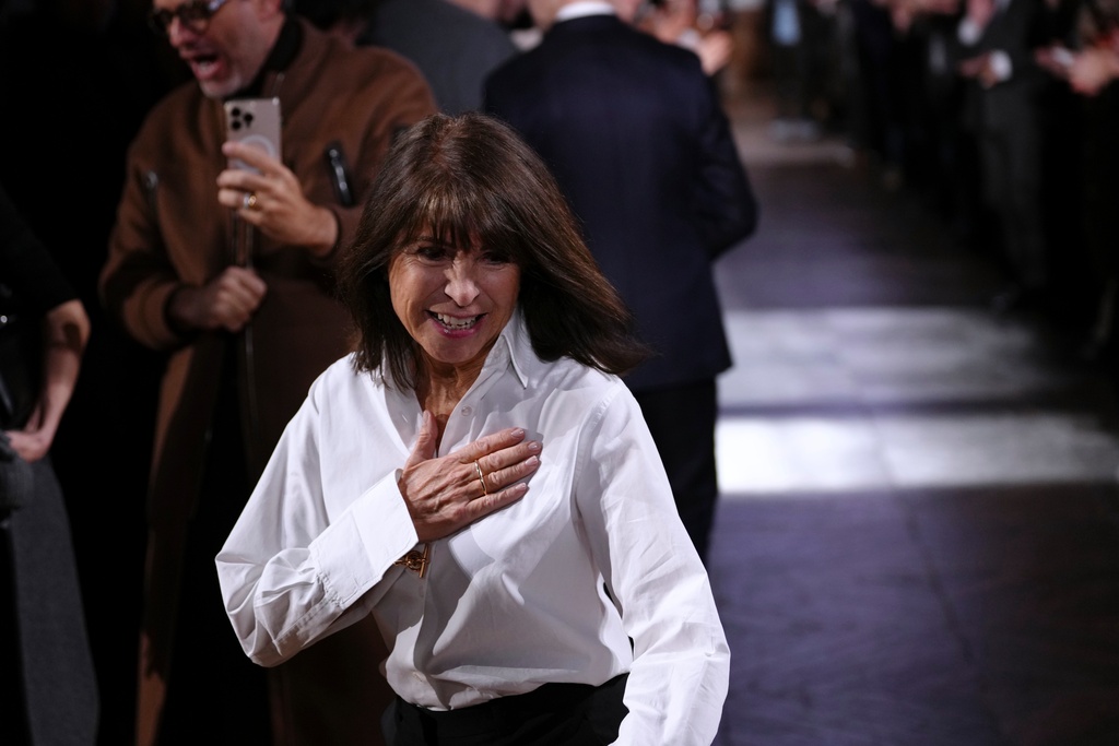 Designer Veronique Nichanian accepts applause after the Hermes Fall/Winter 2026-2027 Men's collection presented in Paris, Saturday, Jan. 24, 2026. (AP Photo/Aurelien Morissard)
