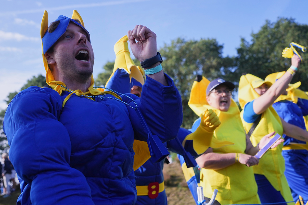 Fans react as they watch play during the Solheim Cup at the Bernardus Golf course in Den Bosch, Netherlands, Saturday, Sept. 12, 2026. (AP Photo/Alastair Grant)