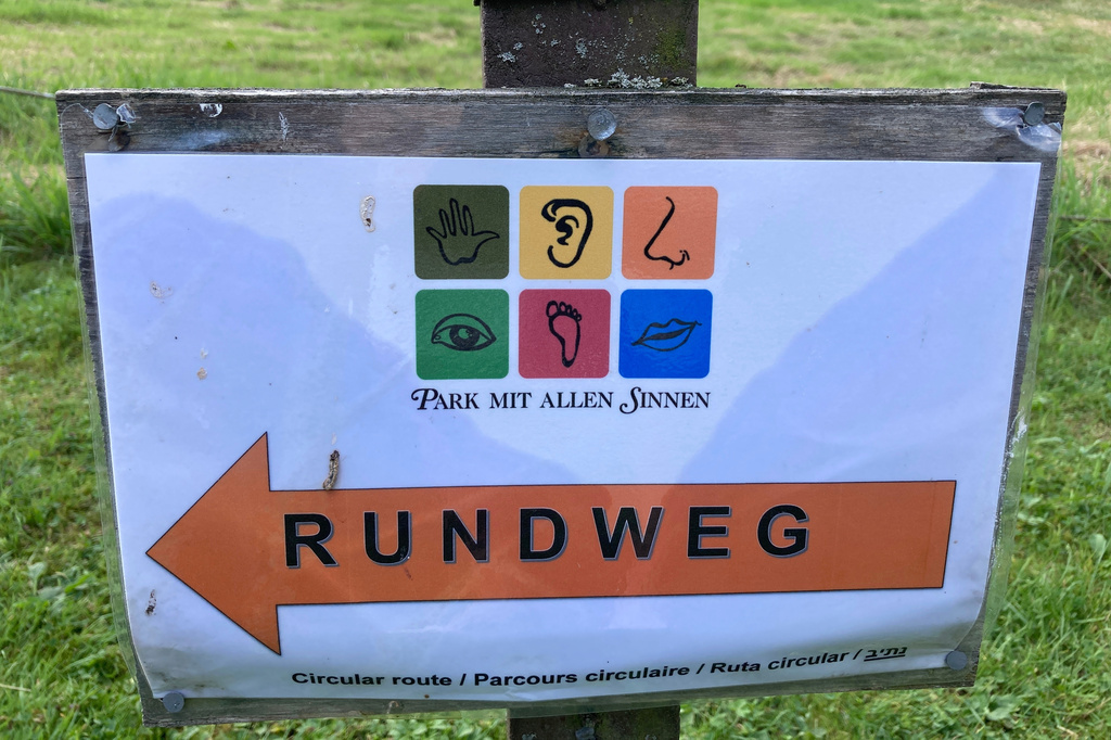A sign at the Park for All Senses, known locally as Park Mit Allen Sinnen, is displayed, Thursday, Aug. 8, 2024, in Gutach, Germany. (AP Photo/Kelvin Chan)