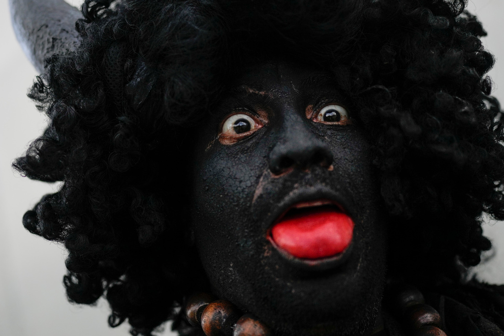 Revelers take part in the Afro-Venezuelan Holy Innocents' Day celebration in Caucagua, Venezuela, Sunday, Dec. 28, 2025. (AP Photo/Matias Delacroix)