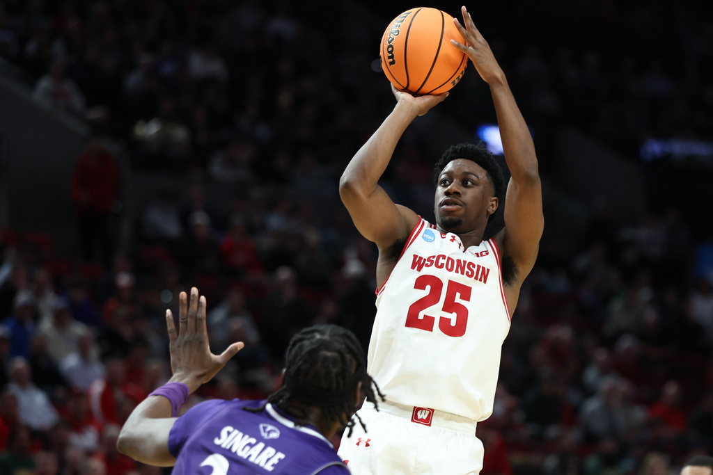 Wisconsin guard John Blackwell (25) shoots as High Point center Youssouf Singare defends during the first half in the first round of the NCAA college basketball tournament Thursday, March 19, 2026, in Portland, Ore. (AP Photo/Craig Mitchelldyer)
