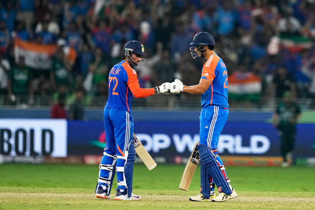 India's Tilak Varma, left, and batting partner Shivam Dube touch gloves during the Asia Cup cricket final between India and Pakistan at Dubai International Cricket Stadium, United Arab Emirates, Sunday, Sept. 28, 2025. (AP Photo/Altaf Qadri)