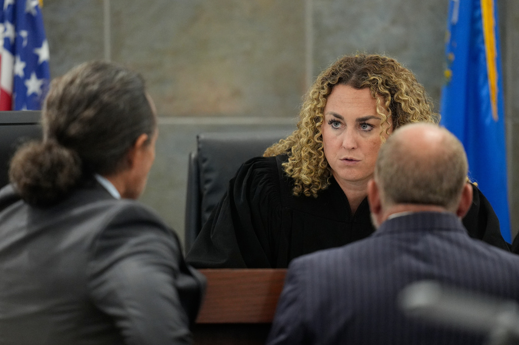 Clark District Court Judge Carli Kierny, center, speaks with defense attorney Michael Sanft, left, and Chief Deputy District Attorney Marc DiGiacomo during the murder trial of Duane "Keffe D" Davis related to the 1996 killing of rapper Tupac Shakur, at Clark County District Court Regional Justice Center in Las Vegas, on Tuesday, Aug. 18, 2026. (AP Photo/John Locher, Pool)