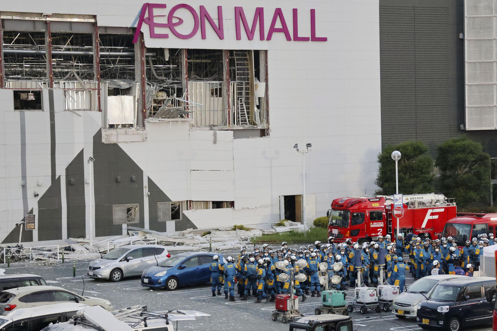 Police units gather in the parking lot before beginning operations at Aeon Mall Kumamoto in Kashima, Kumamoto Prefecture, Friday, July 31, 2026. (Kyodo News via AP)