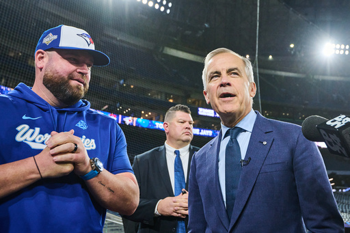 Canada's Prime Minister Mark Carney speaks to Toronto Blue Jays manager John Schneider as he visits the Blue Jays during baseball's World Series media day, Thursday, Oct. 23, 2025, in Toronto,. (Sammy Kogan/The Canadian Press via AP) Canada's Prime Minister Mark Carney speaks to Toronto Blue Jays manager John Schneider as he visits the Blue Jays during baseball's World Series media day, Thursday, Oct. 23, 2025, in Toronto,. (Sammy Kogan/The Canadian Press via AP)