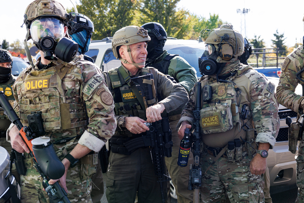 U.S. Customs and Border Protection Commander Gregory Bovino holds a canister as he stands with federal immigration enforcement agents during a skirmish with protesters in Little Village on Thursday, Oct. 23, 2025 in Chicago. (Anthony Vazquez/Sun-Times/Chicago Sun-Times via AP)