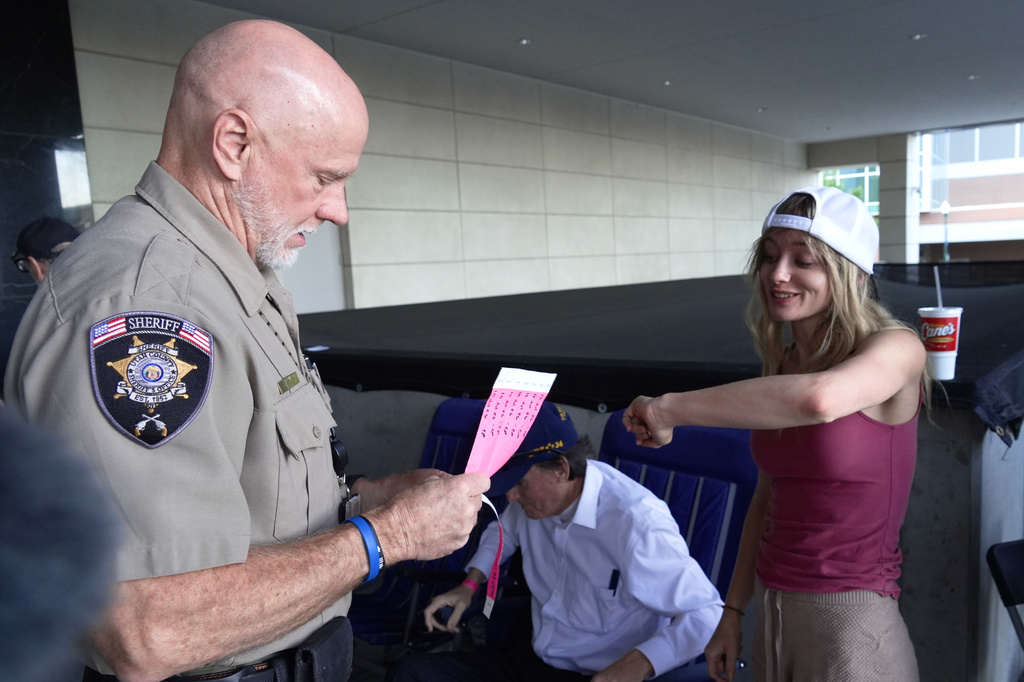 Billie Webb receives a wristband for limited public seating available at a preliminary hearing for Tyler Robinson, the Utah man accused of fatally shooting Charlie Kirk, in Provo, Utah, Friday, July 10, 2026. (AP Photo/Ty ONeil)