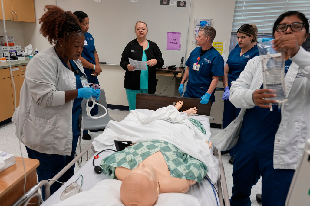 Instructor Renee McFatridge, center back, directs nursing students in the simulation lab at Forsyth Technical Community College in Winston-Salem, N.C., Thursday, Aug. 20, 2026. (AP Photo/Chuck Burton)